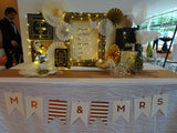 White banner with customised gold words